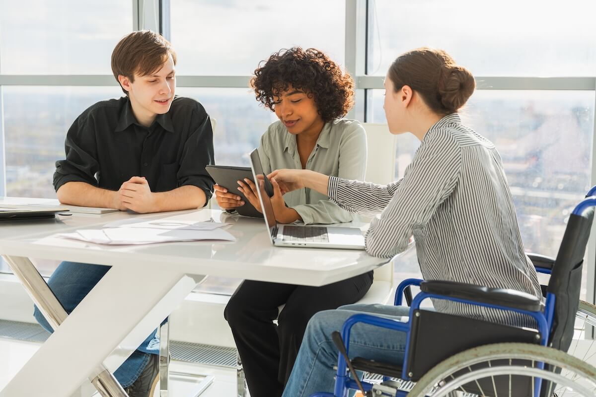 ADA return to work accommodations: 3 colleagues brainstorming in their office