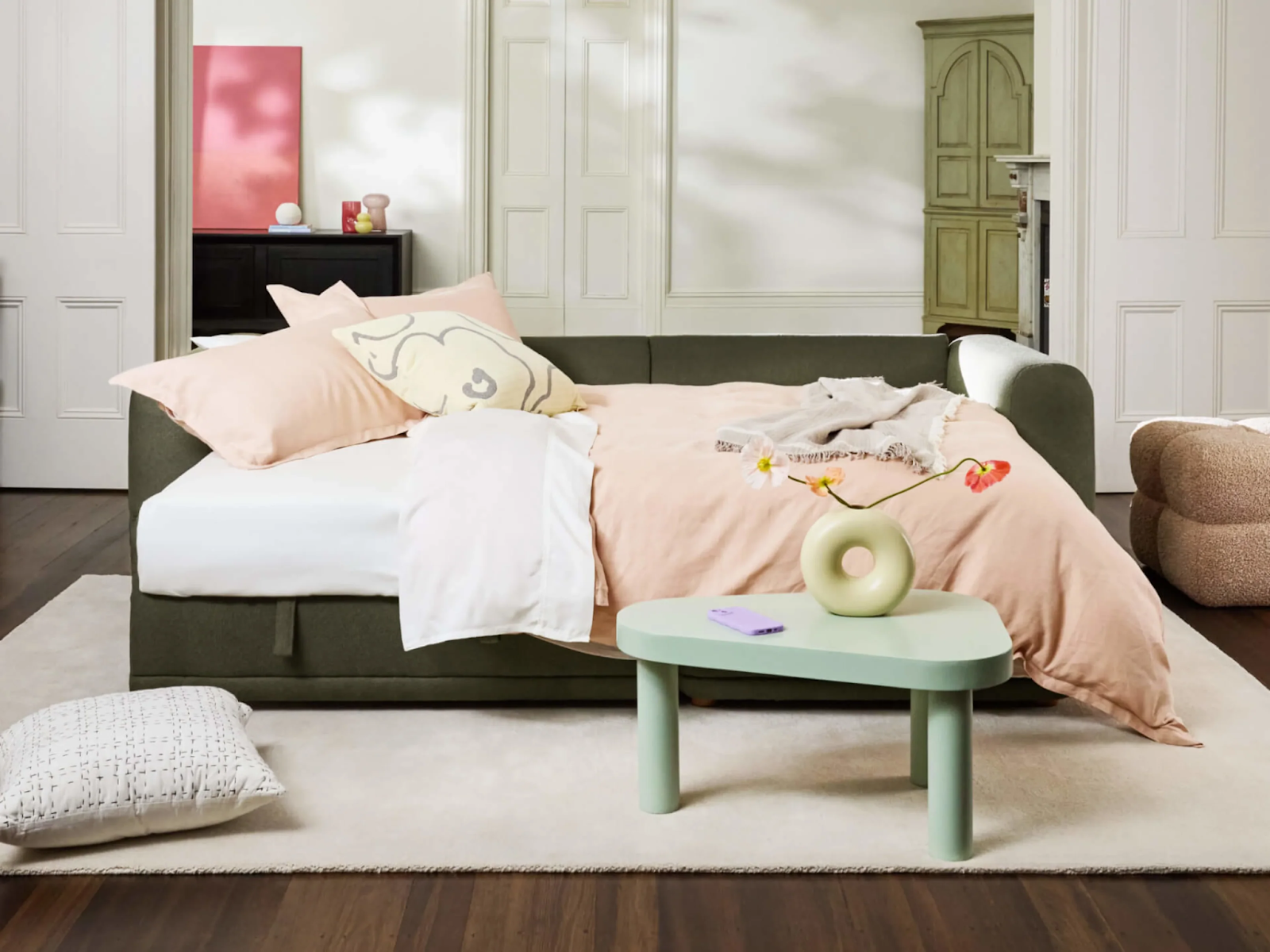 fold-out sofa bed with duvet and pillows