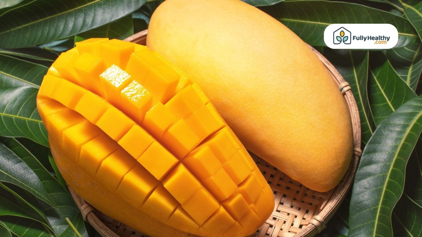 Fresh ripe mangoes with one sliced in cubes beautifully
