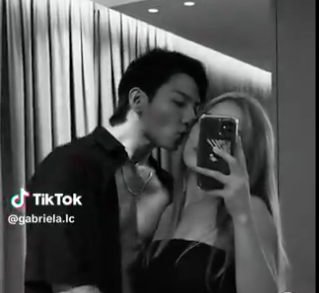 This contains an image of an AI edited photo of junkook kissing a random tiktok user 