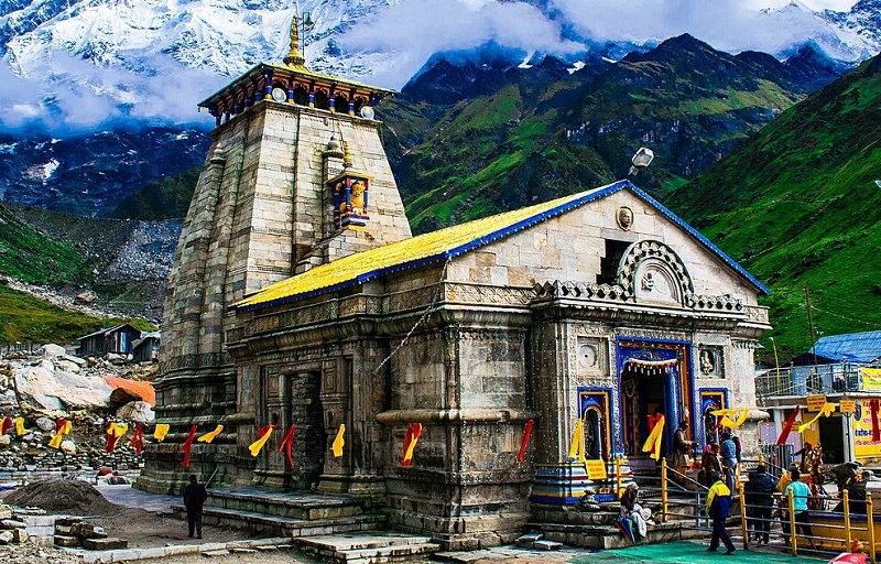 A spiritual view of Kedarnath Temple, Uttarakhand, nestled in the Himalayas with snow-covered peaks in the background.