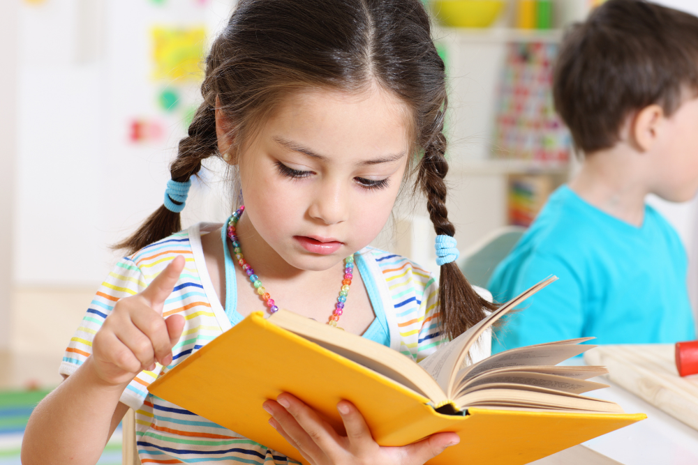 young girl practicing reading 