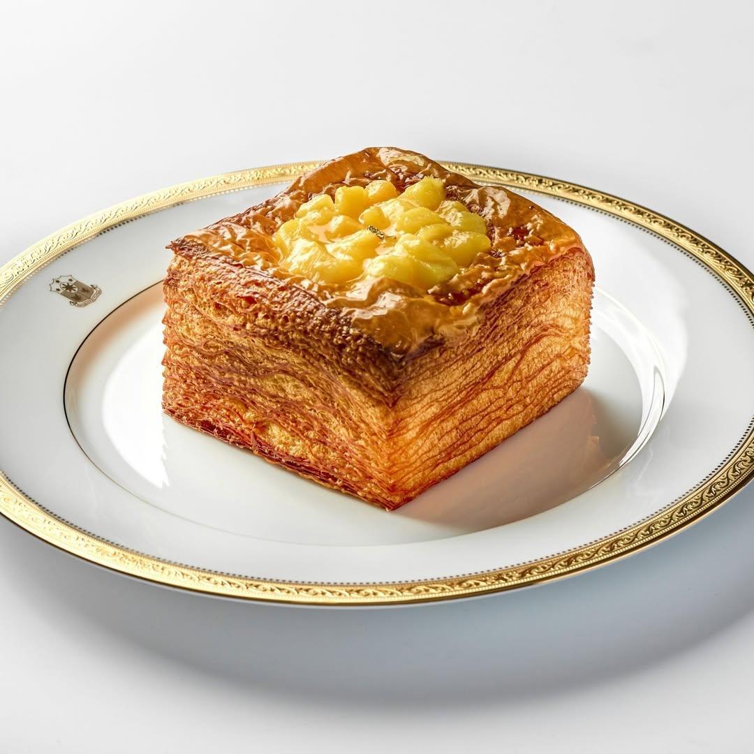 A square piece of food on a white plateDescription automatically generated