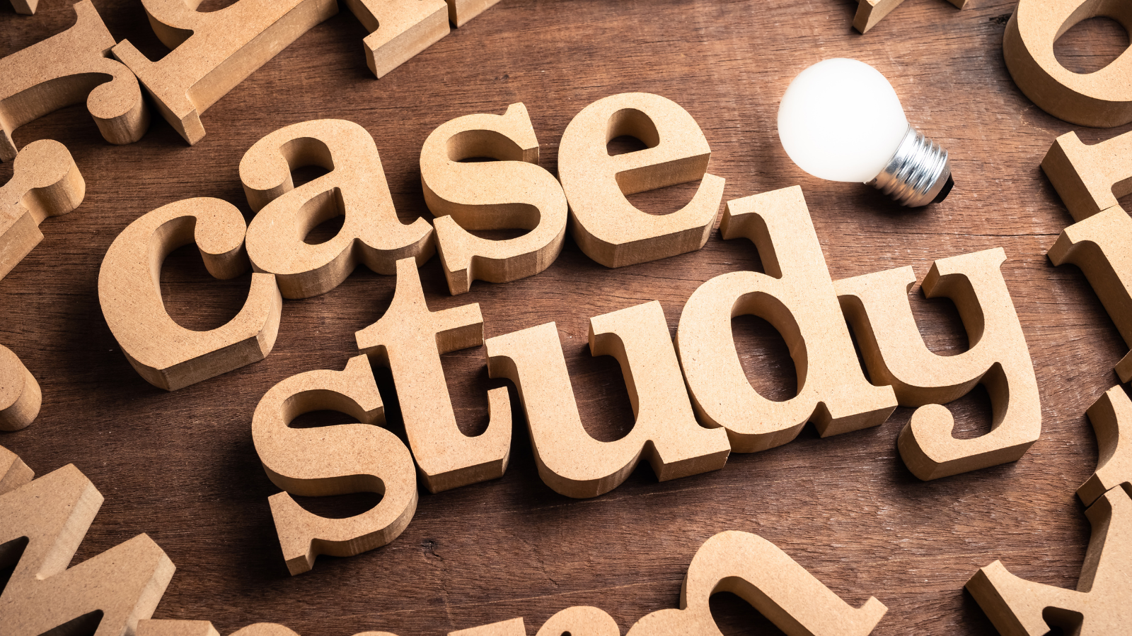 Wooden block letters spelling out "case study" on a wooden surface, with a small lightbulb placed nearby. This image visually supports the blog topic "Optimize Your Cart with A/B Testing Using Supercart: Why You Should Start Today" by highlighting the importance of real-world case studies and insights in improving eCommerce strategies through testing.