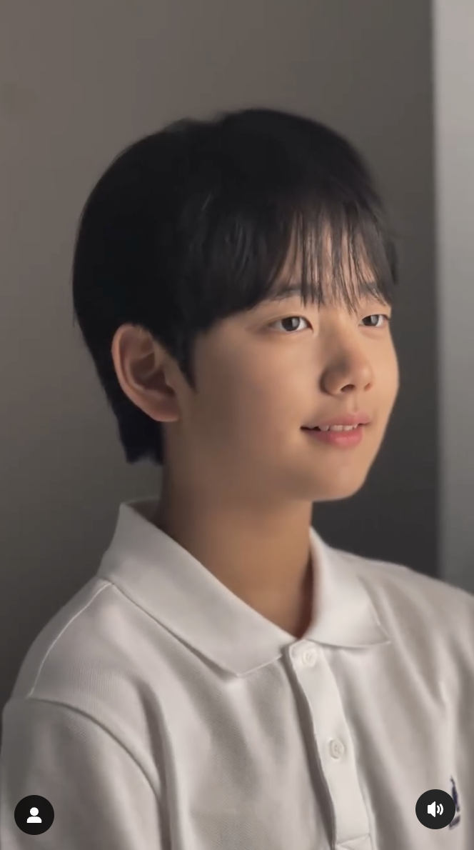 A picture of little cute Dasongie wearing a white shirt