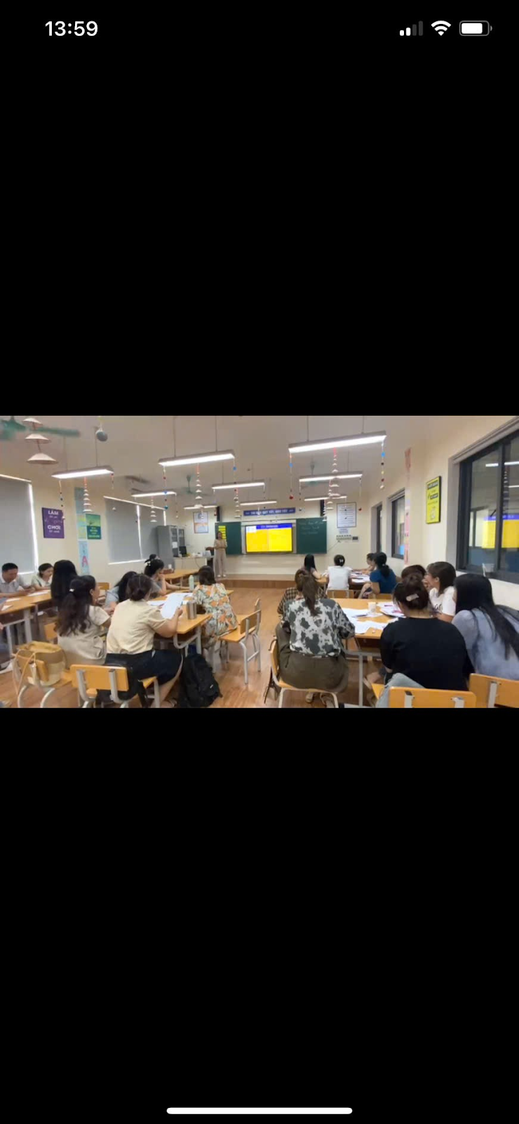 A group of people sitting at desks in a classroom
Description automatically generated