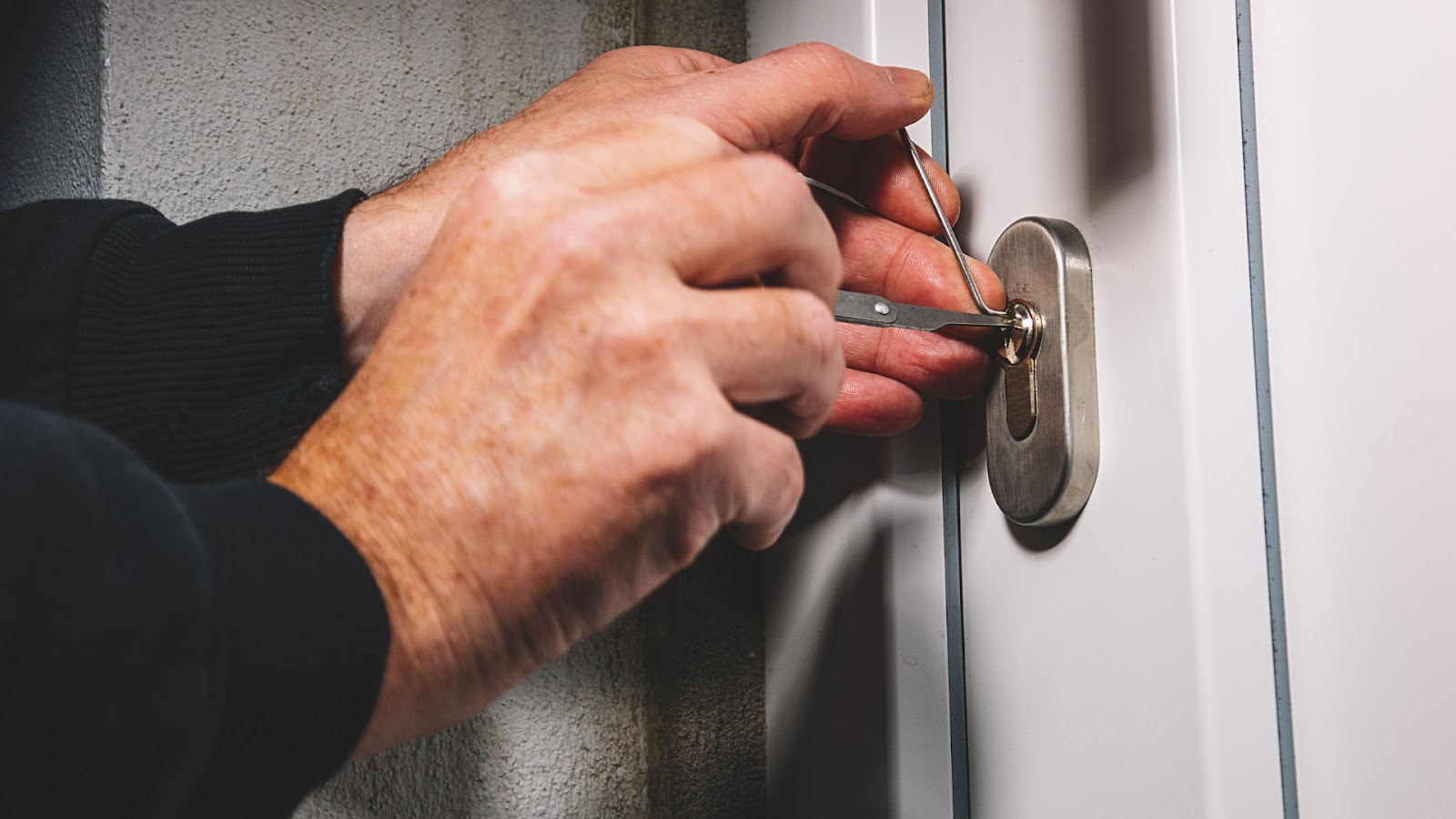 A locksmith picking a lock to help with a home lockout emergency