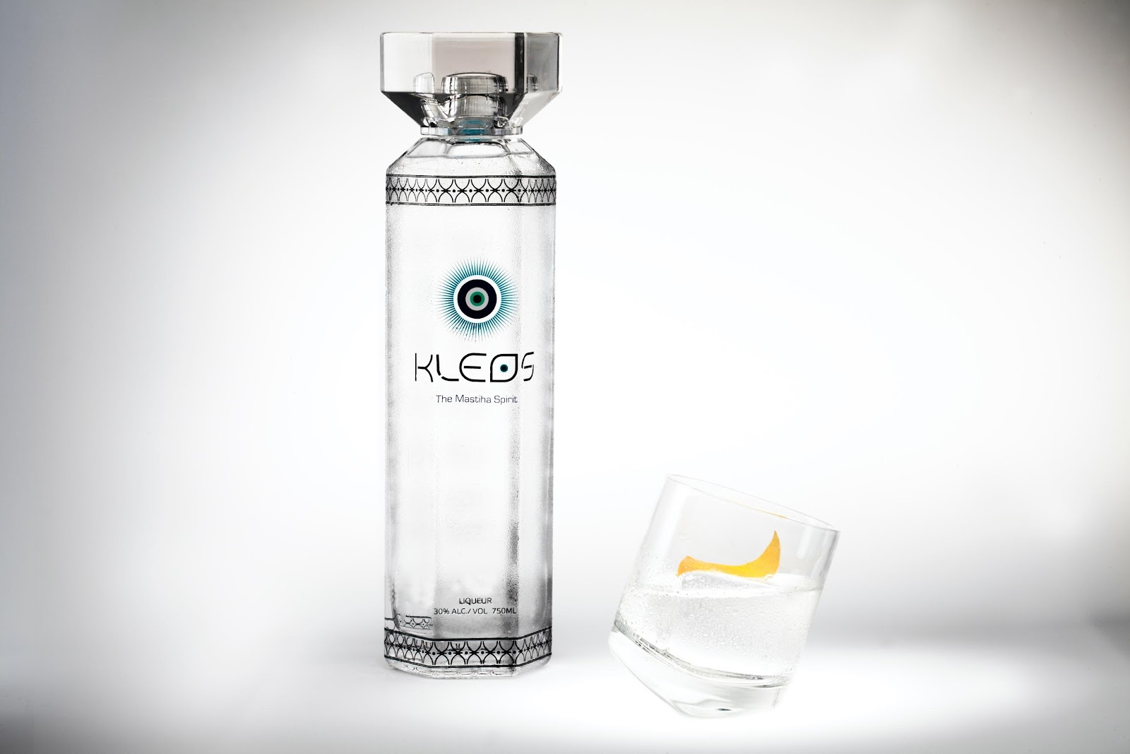 A bottle of vodka next to a glass of liquid

Description automatically generated