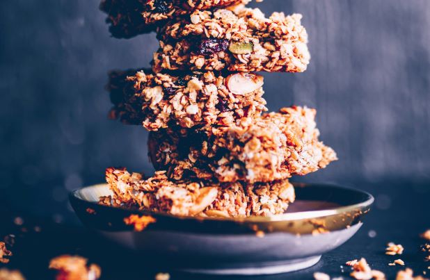 High-calorie protein bars stacked on each other on a glass plate.