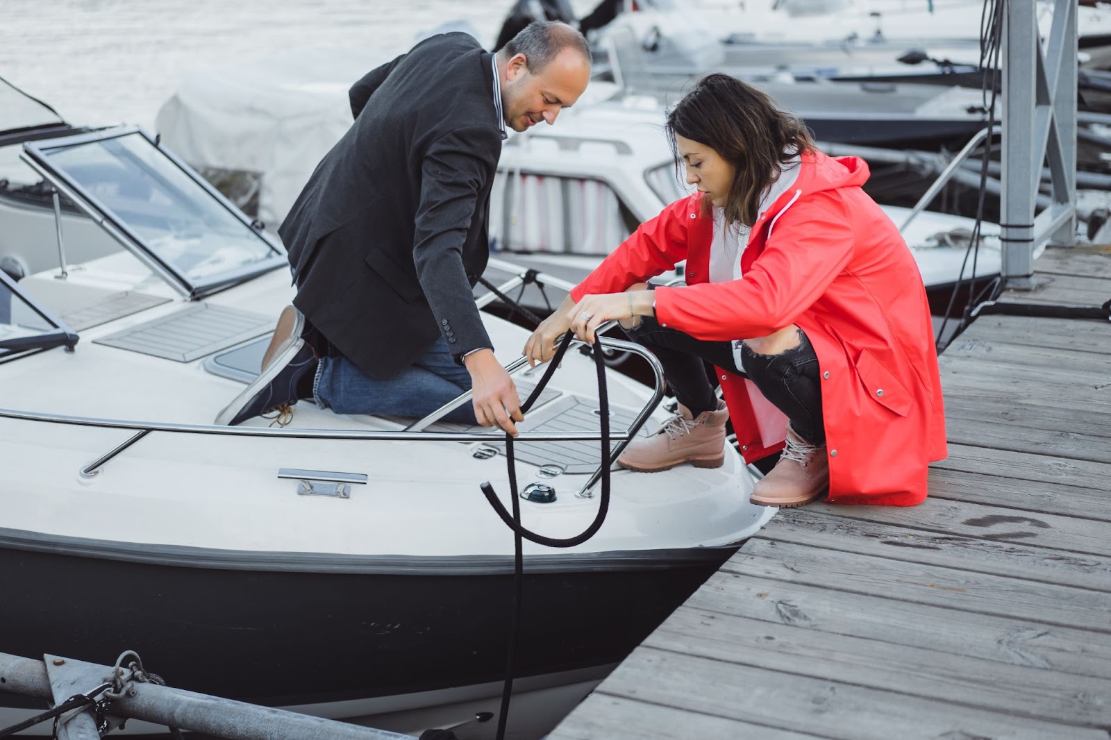 A man adjusting fenders on a boat