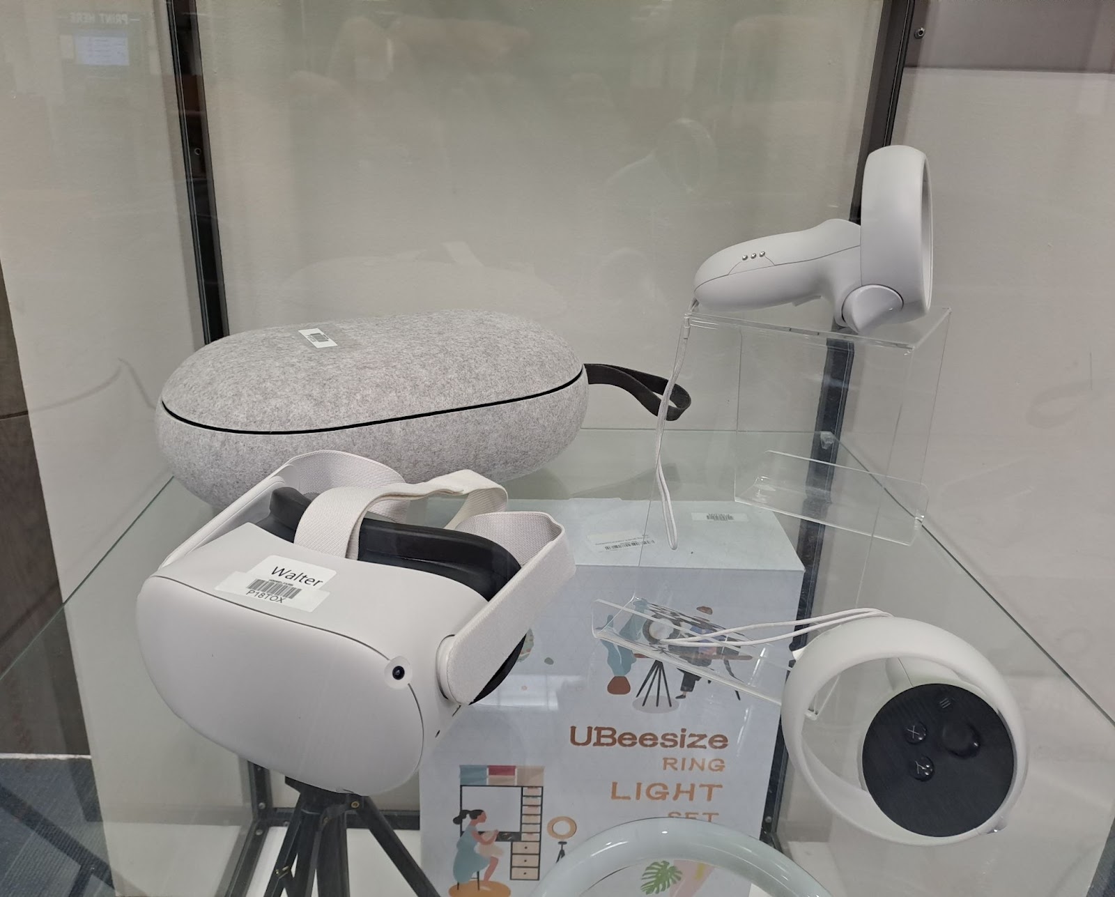 A VR headset is displayed behind a glass case. 