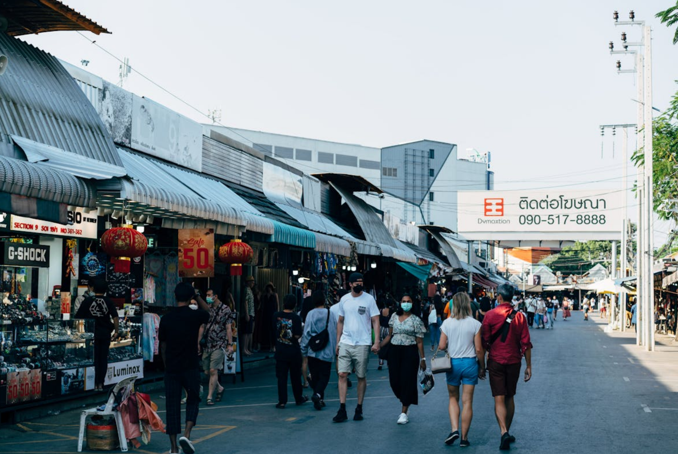 A group of people walking down a street

Description automatically generated