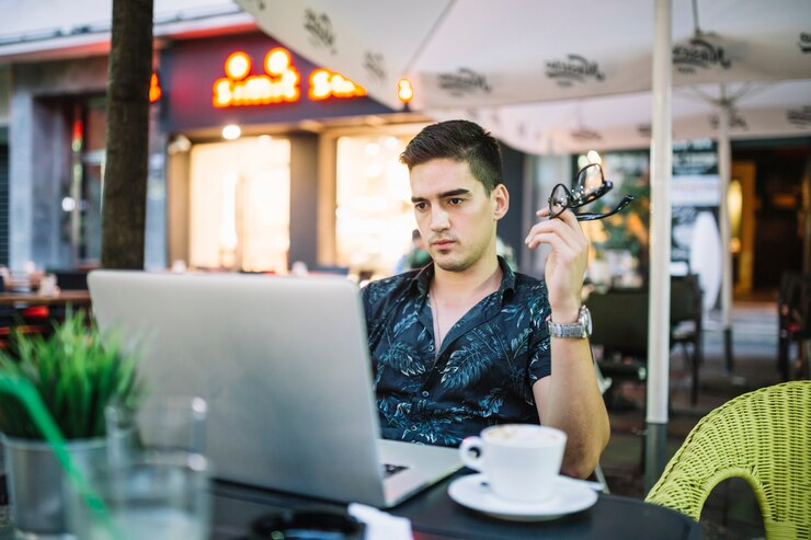 Man concentrating while working on a laptop