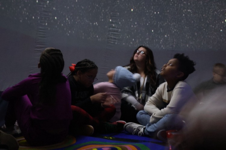 Students and teachers marvel during at the new portable planetarium during a recent STEM lesson at John F Kennedy school.