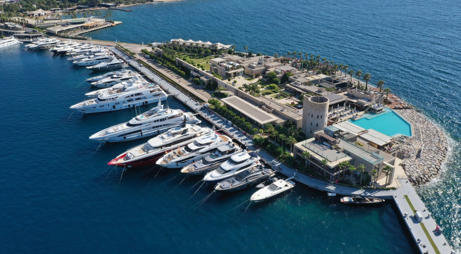 Luxury gulet anchored in a beautiful bay near Fethiye, with fashionable guests enjoying the deck