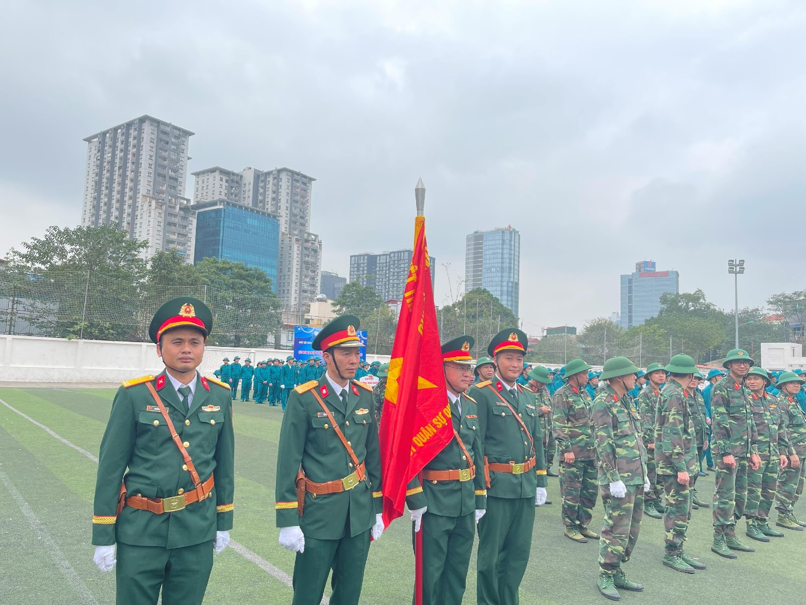 A group of people in uniform standing in a field

AI-generated content may be incorrect.