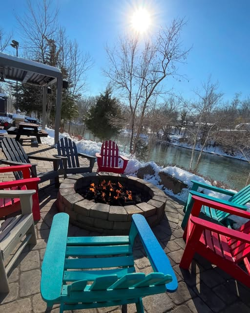 Outdoor seating at firewood alongside Little Miami river