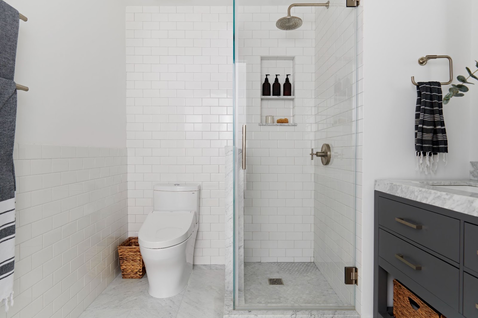 Three-quarters bath with a shower stall, white subway tile, nickel fixtures, and a large storage vanity