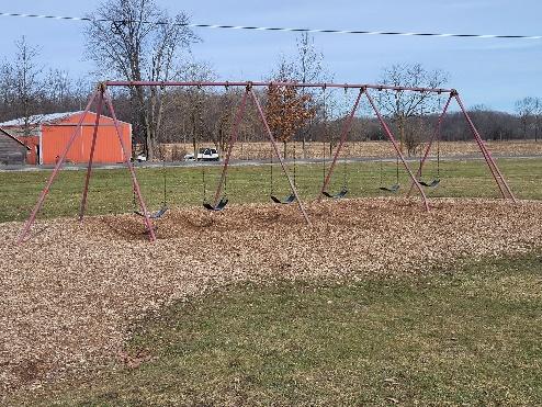 Photo of aging swings at elementary playground