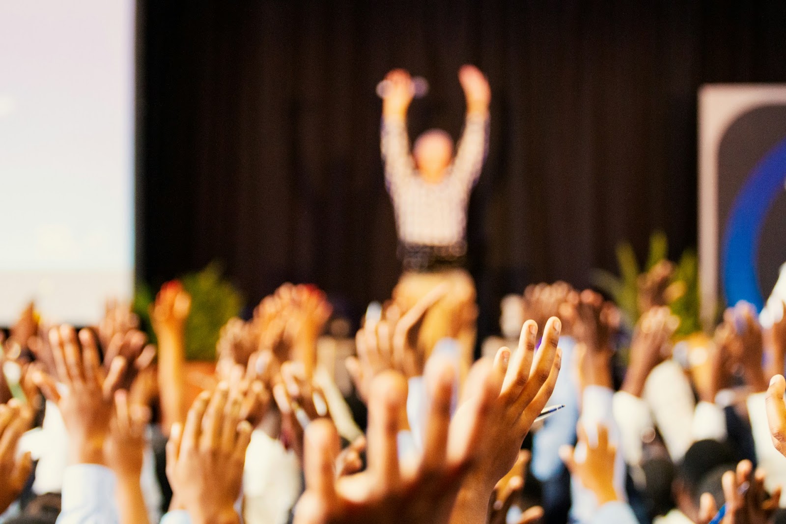 Audience with raised hands