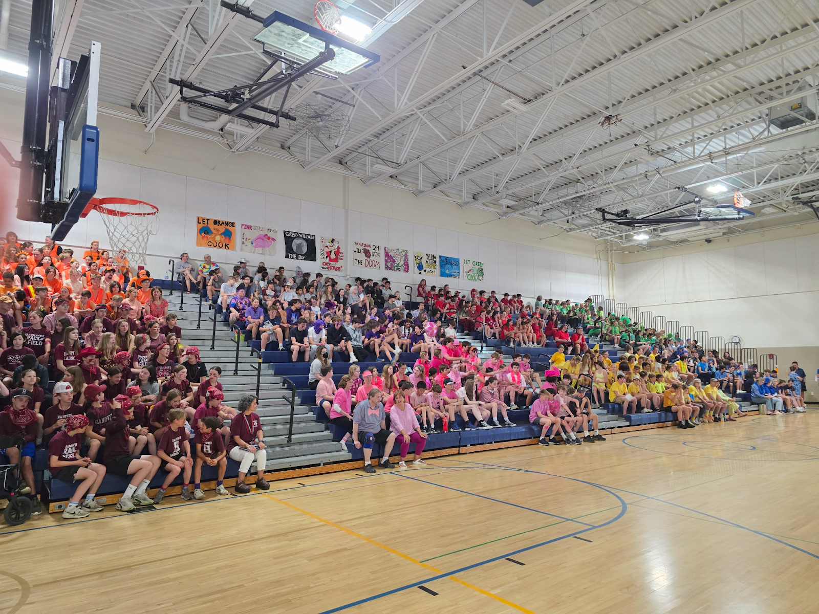 students and staff on the bleachers in the gym