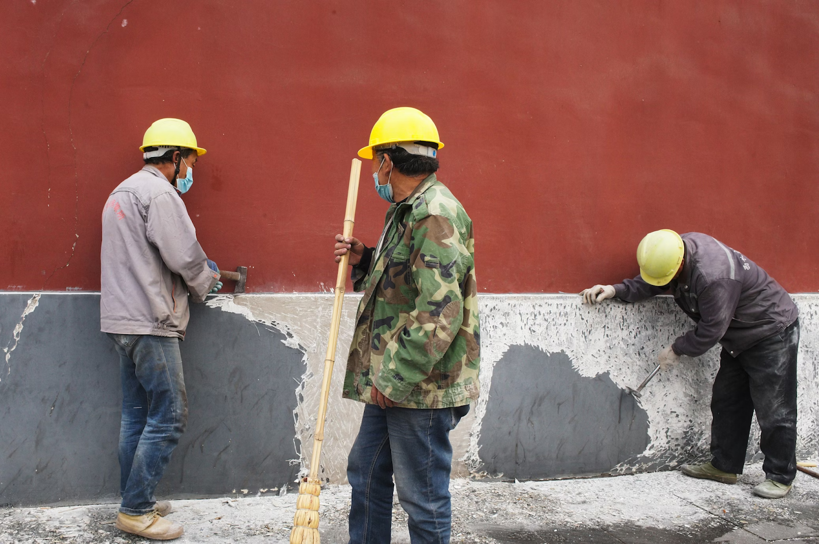 Construction workers performing safety steps as part of risk management in construction projects.