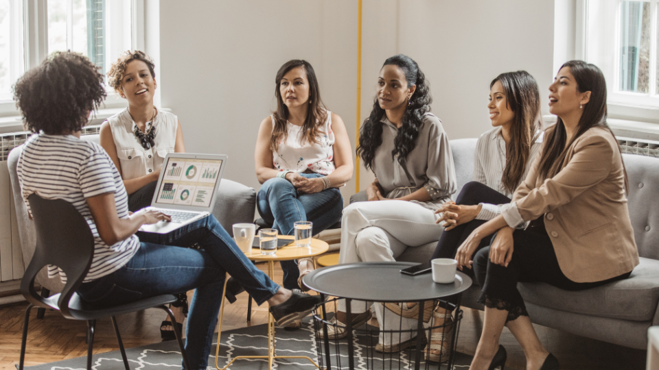 A group of individuals sitting on couches in a living room