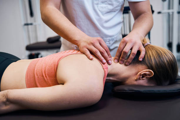 A chiropractor performing an upper cervical adjustment on a patient lying on a treatment table, demonstrating a non-invasive chiropractic procedure.