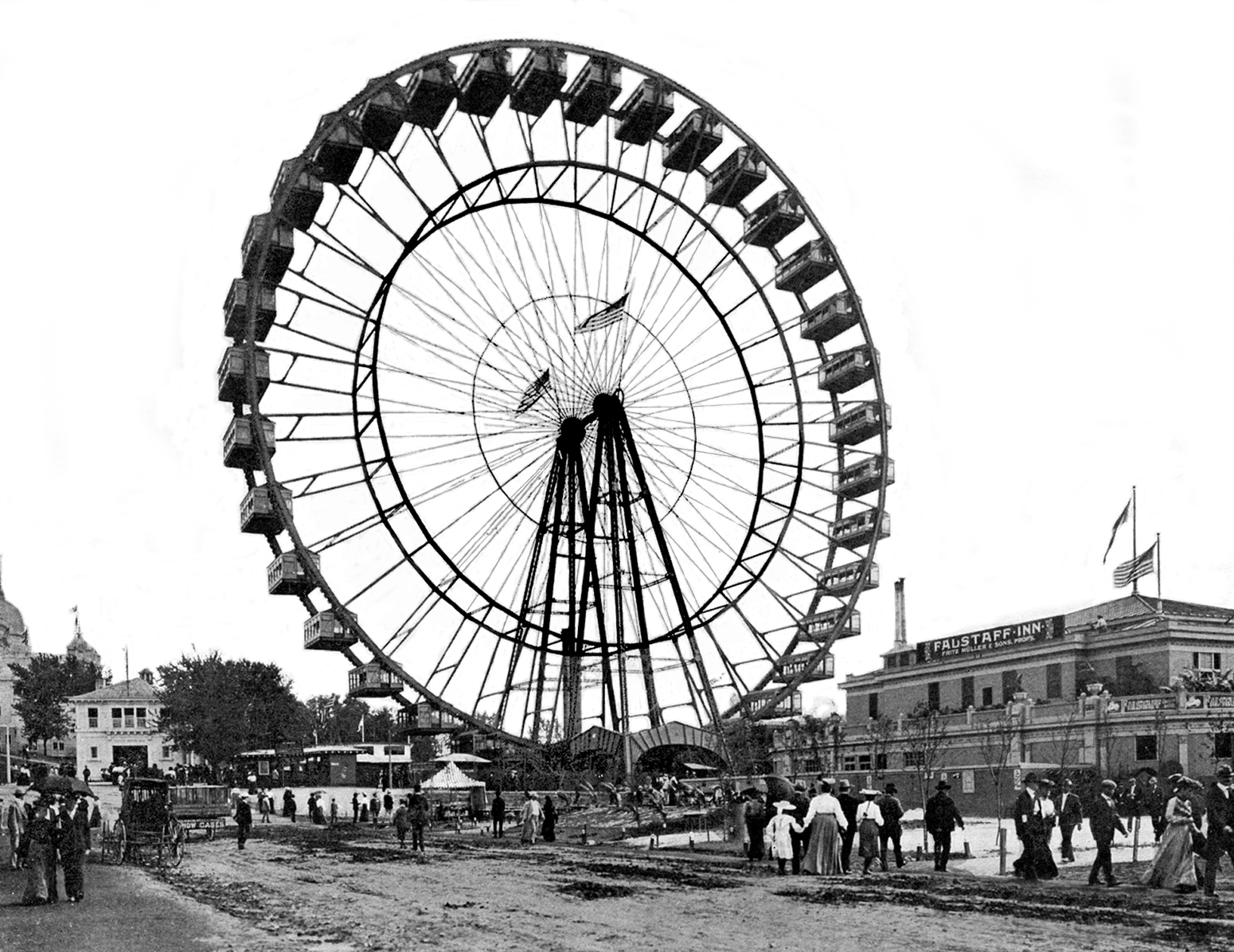 Dozens of people line up and gather around a tall Ferris wheel. 