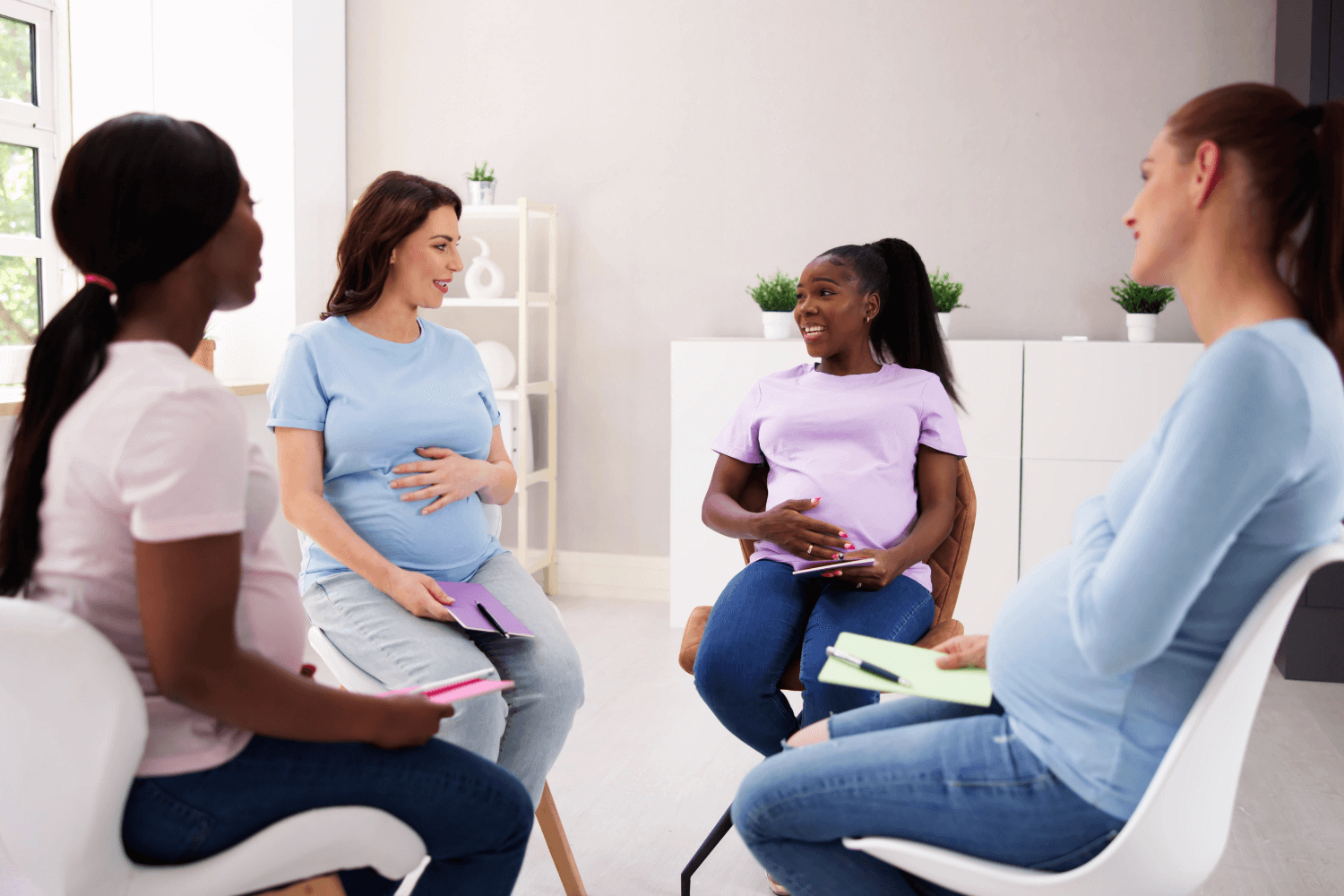 Pregnant women gathered together in a circle