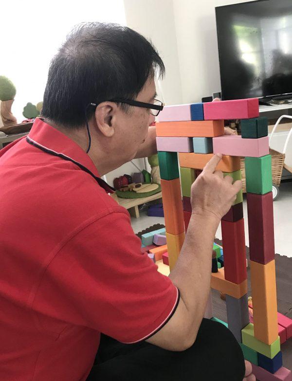 Blocks are for adults too. Here is an adult stacking and creating a structure with blocks. 