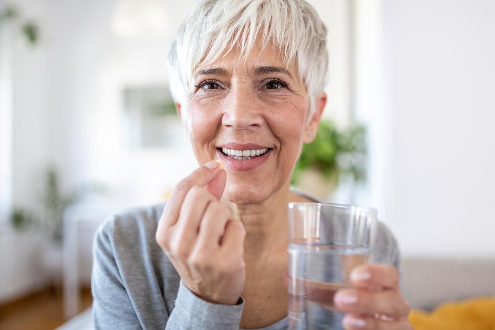 Old lady taking her vitamin