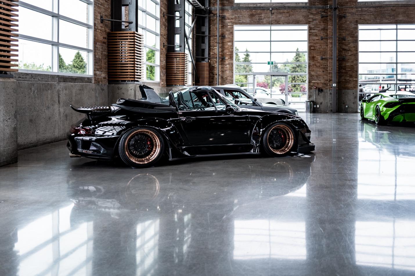 A black car parked in a large room

AI-generated content may be incorrect.