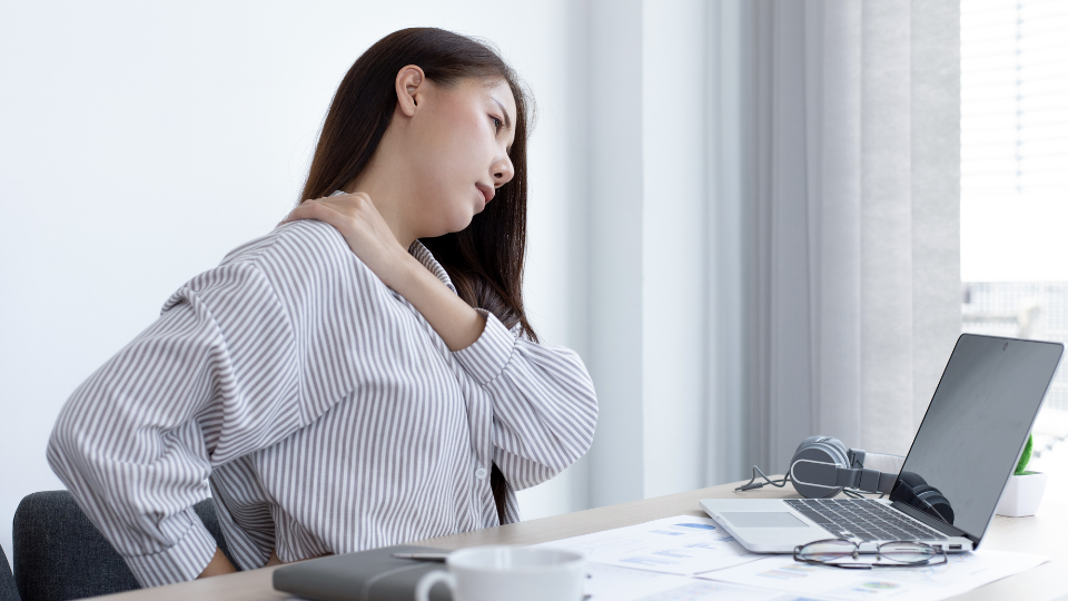 Woman rubbing her shoulder for pain relief.