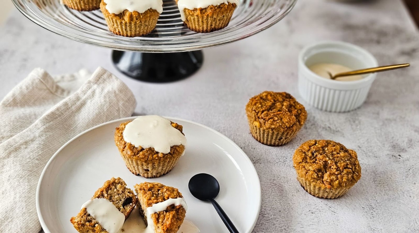 Carrot Muffins Created by a Registered Dietitian on a Plate Against a Concrete Background