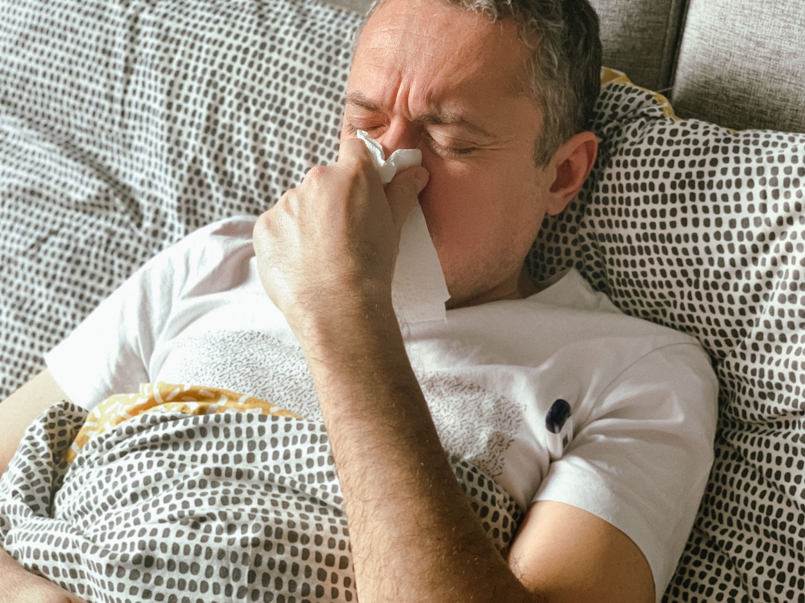 Person with allergies in bed thinking how long do mattresses last
