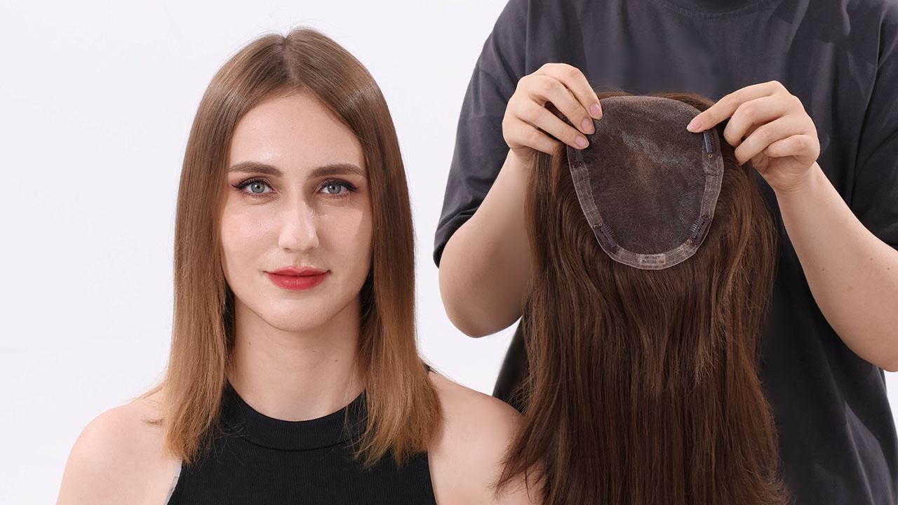 a female stylist putting a hair topper on a female client