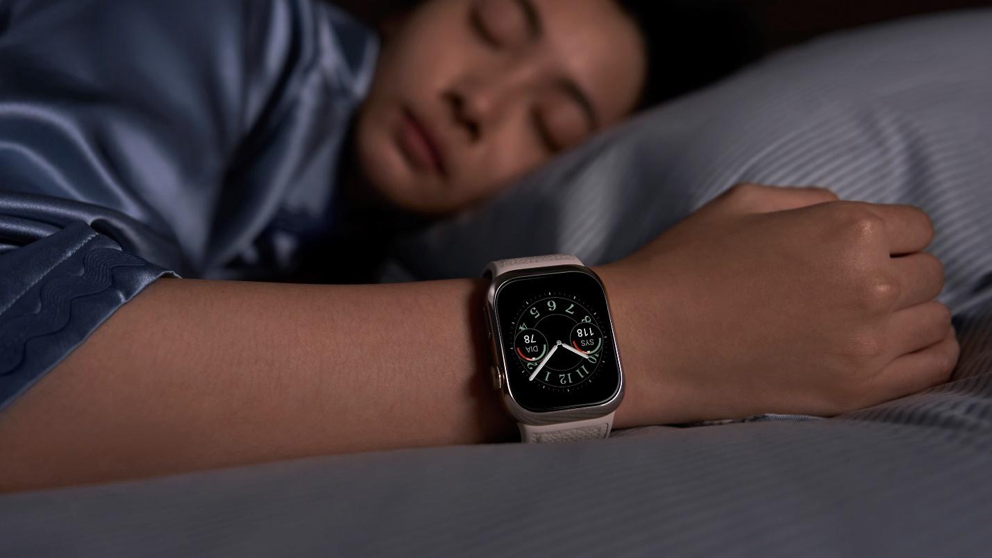 A person sleeping on a bed with a watch on their wrist  Description automatically generated