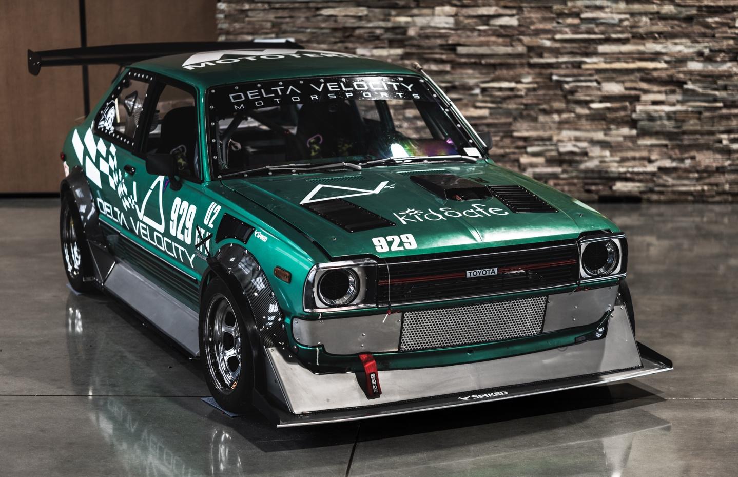 A green car with white graphics on it

AI-generated content may be incorrect.