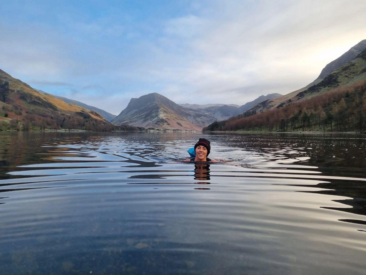 Rachel owner of nose to trail swimming in buttermere lake in lake district in December 