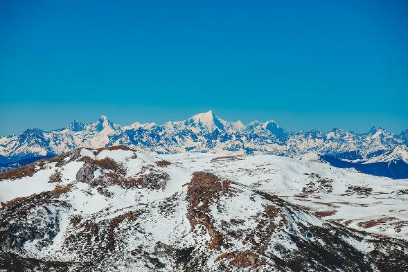 A snowy mountain range with blue sky