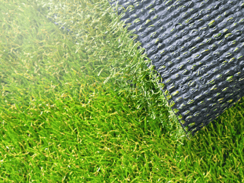 Artificial turf cost calculator view: close-up of synthetic grass backing and texture for turf installation planning