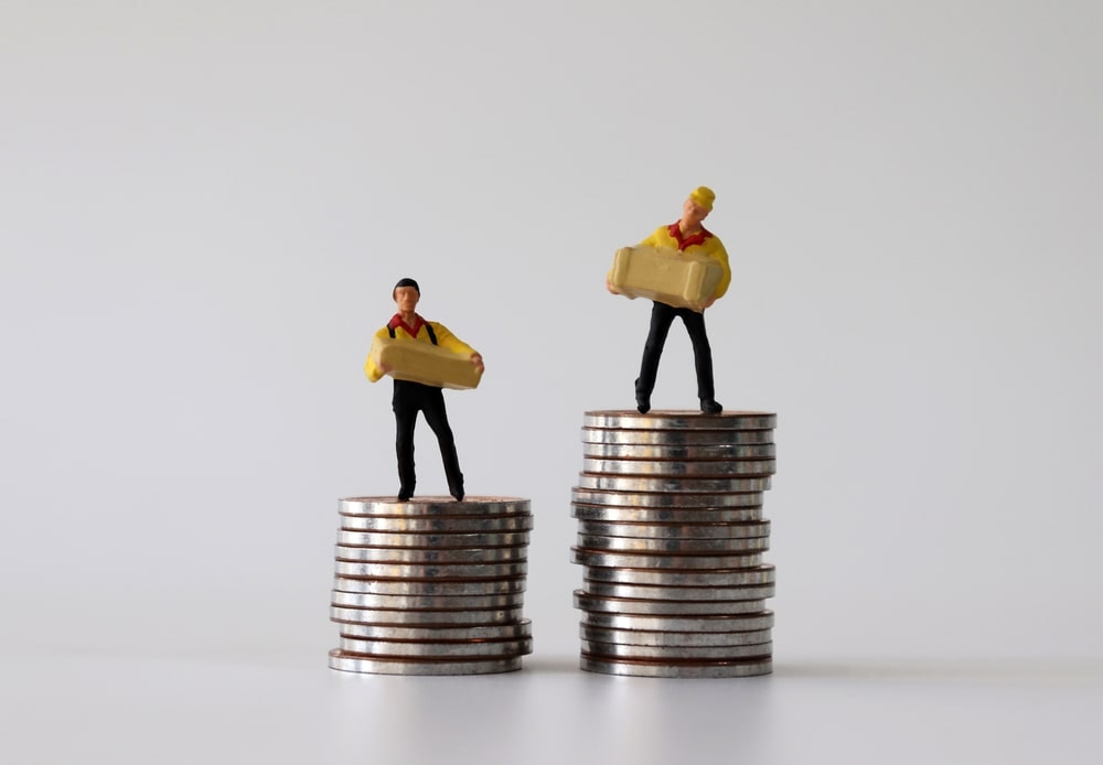 Two toy figures standing above coins