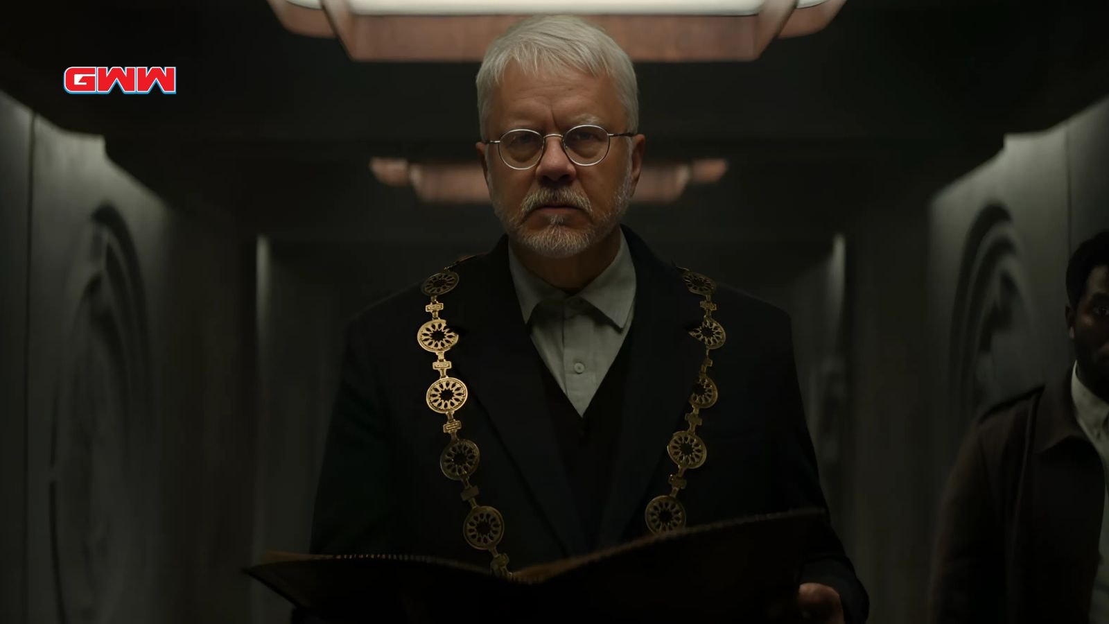 Tim Robbins as Bernard wearing ceremonial attire in Silo Season 2.