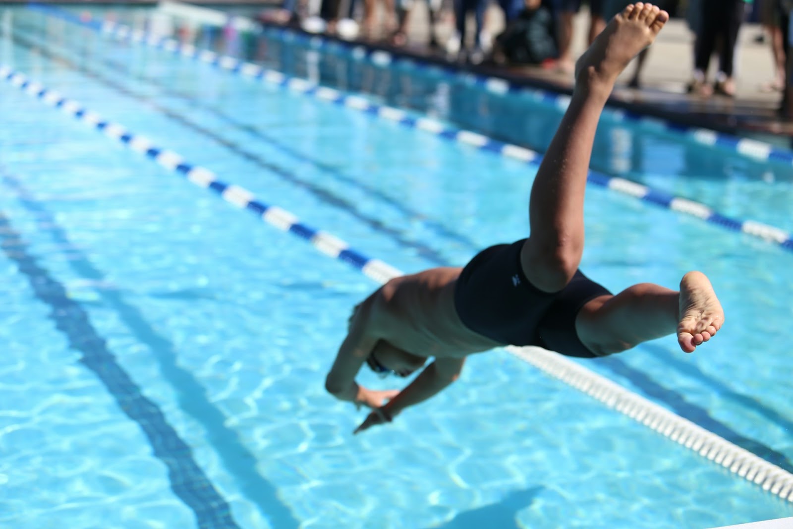 Man jumping into a pool