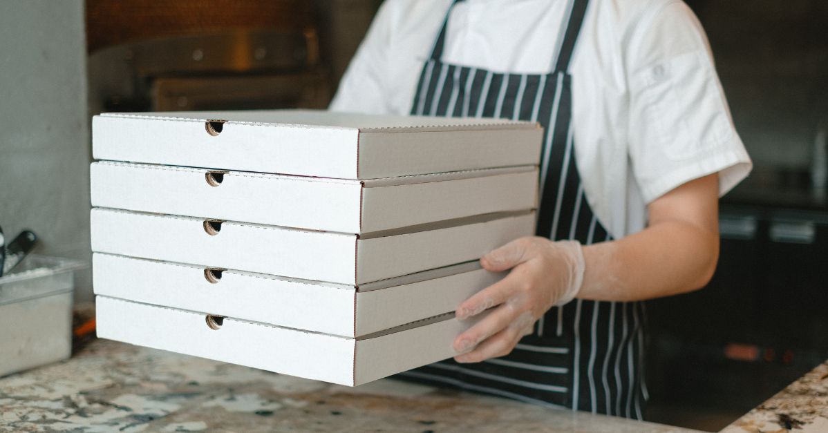 person delivering pizza boxes