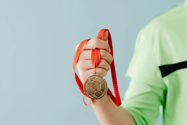 child holding medal