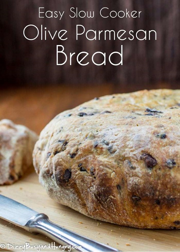 Olive Parmesan bread on a cutting board withe knife