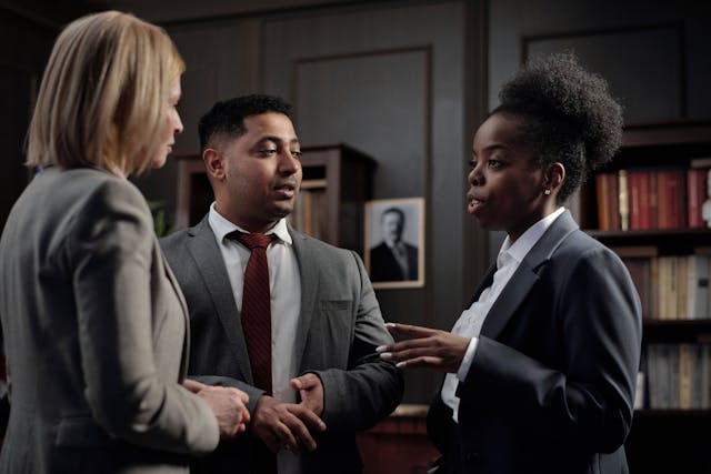 Three people talking in a group