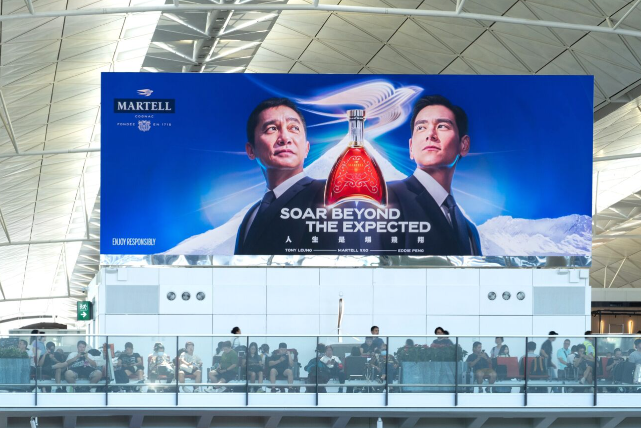 A large billboard with a couple of men on it Description automatically generated